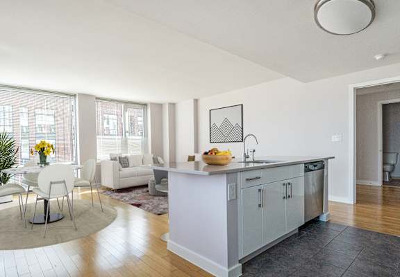 a kitchen with an island and a living room with a couch at 34 Berry, Brooklyn, New York