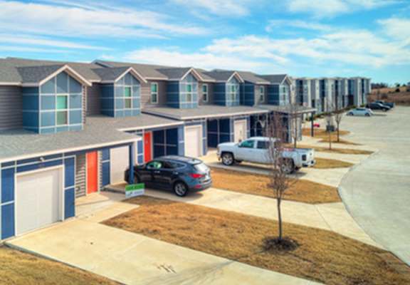 an image of a building with cars parked in front of it