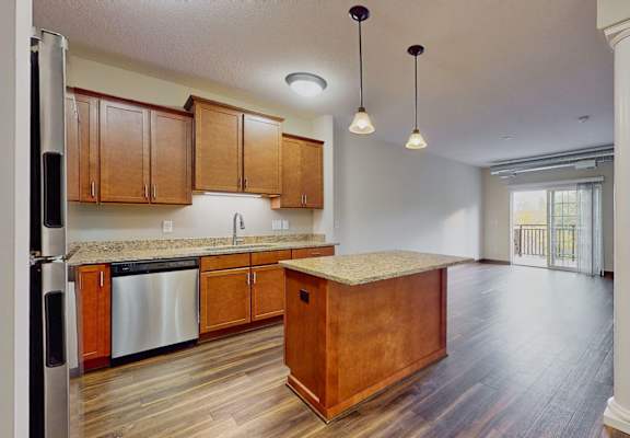 an empty kitchen with wooden cabinets and a counter top