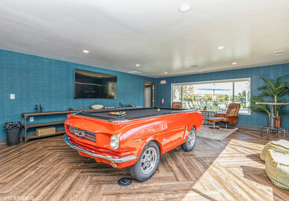 a pool table in a living room with a orange truck in the middle at Runaway Bay Apartments, Columbus, 43204