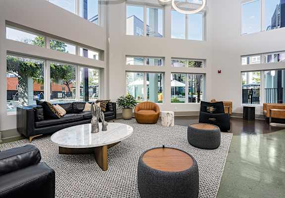 Lobby with seating and tables and lots of windows at Trend Design District, Dallas, TX