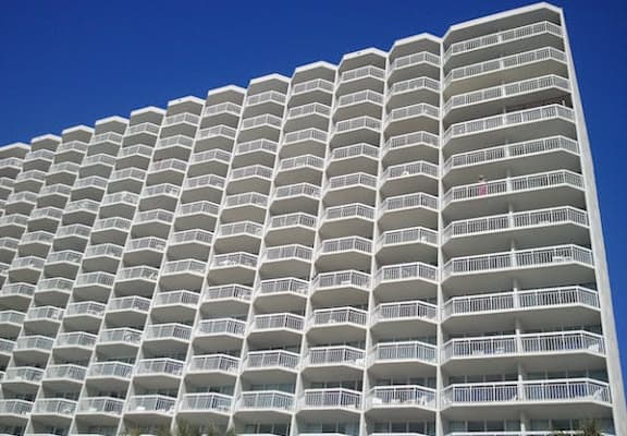 an apartment building with a blue sky above it