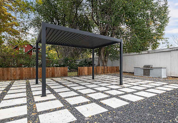 A black and white checkered pavement with a black metal canopy.