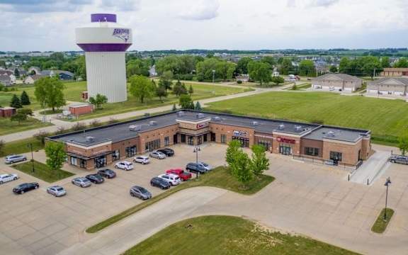 a parking lot with a water tower in the background