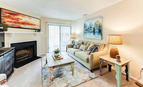 a living room with a couch coffee table and fireplace