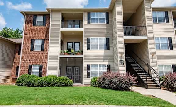 A large apartment building with a balcony on the second floor.