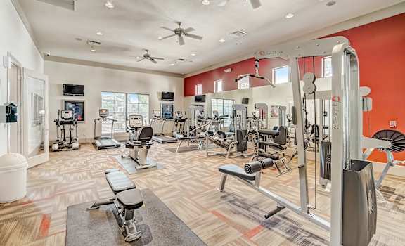 A well-equipped gym with a variety of machines and weight training equipment.
