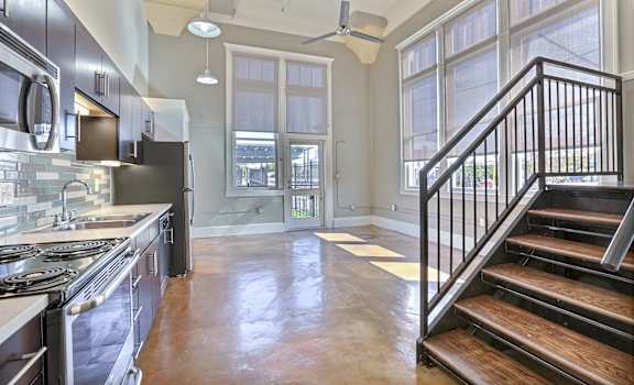 a kitchen with a stove top oven next to a doorway