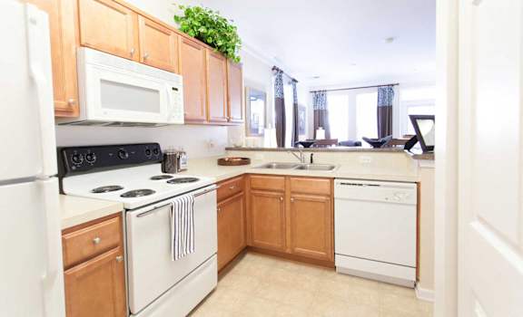 a kitchen with white appliances and wooden cabinets