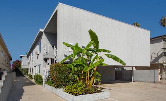 Exterior view of an apartment building with carport parking