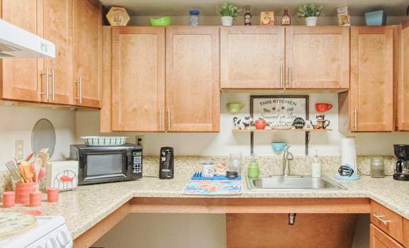 kitchen with white appliances and wood cabinetry and kitchen decor