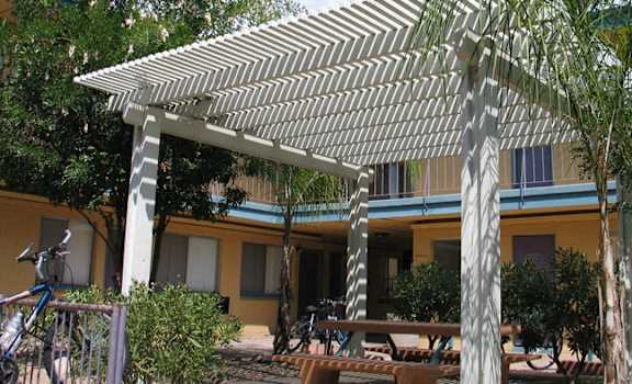 a picture of a building with a pergola in front of it