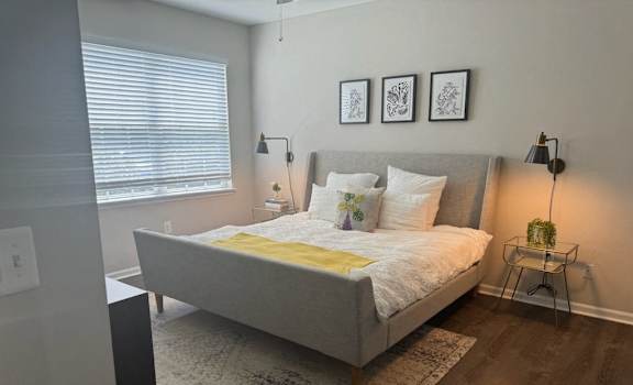a bedroom with a bed and a window
