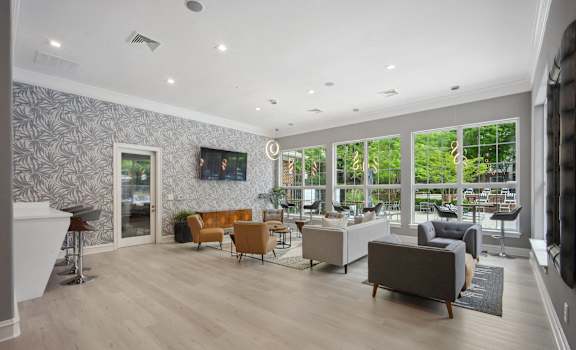 a living room with furniture and a tv on the wall