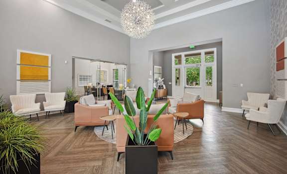 a living room with couches and chairs and a chandelier