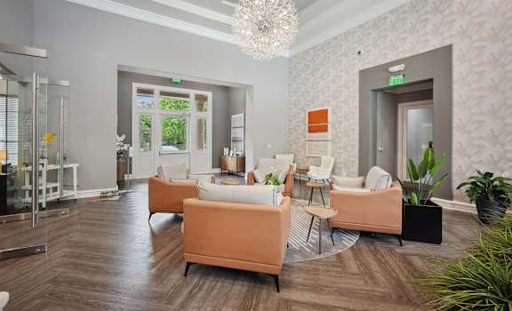 a living room with couches and chairs and a chandelier