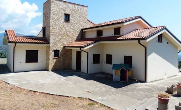a house with a courtyard and a stone tower