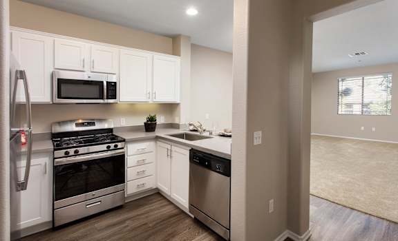 a kitchen with white cabinets and stainless steel appliances at 55+ Remington at Ladera Ranch, Ladera Ranch, CA