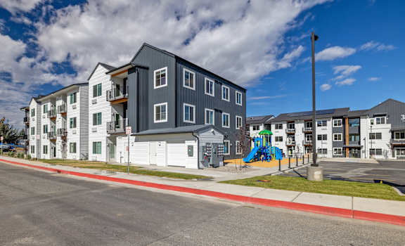Twin Creek Apartment buildings with a playground in front.