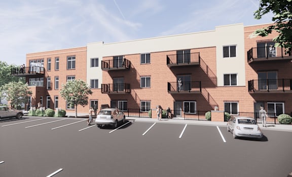 A parking lot with cars and apartment buildings.