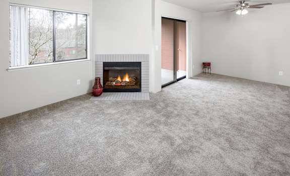 an empty living room with a fireplace