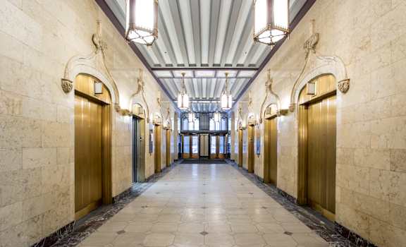 a hallway with gold doors in a building at The Equitable Building, Des Moines, IA, 50309