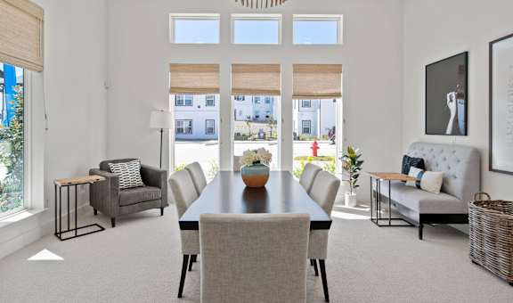 a dining room with a table and chairs and a large window