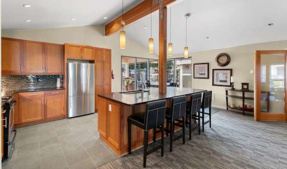 a large kitchen with a large island with chairs
