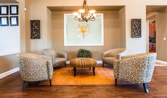 a lounge area with four chairs and a coffee table