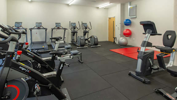 a room filled with lots of different types of exercise equipment