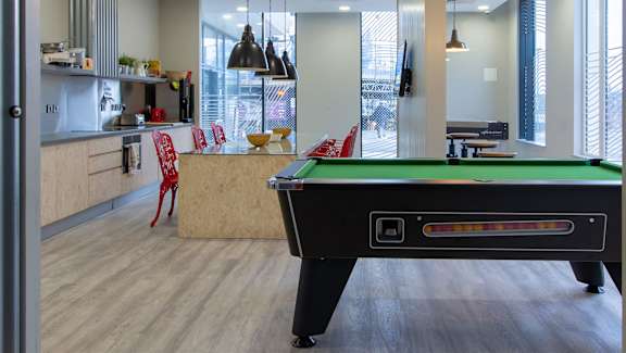 a pool table in the clubhouse