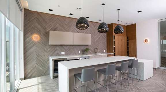 a kitchen with a long island with a white countertop