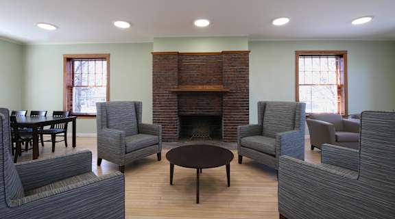 a living room with couches and chairs and a fireplace