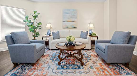 a living room with couches and chairs and a table