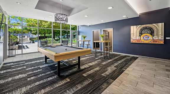 a rec room with a pool table and a mural on the wall at Halsted Flats Apartments, Chicago, IL, 60613