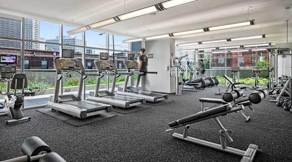a gym with treadmills and weights at Halsted Flats Apartments, Chicago, IL, 60613