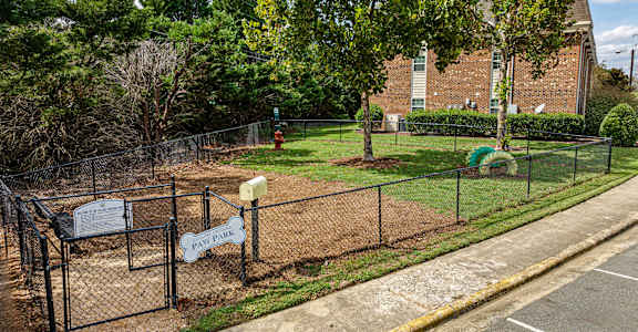 a dog park in front of a brick building