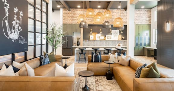 a living room with couches and a kitchen with a bar at Elwood Apartments, Indian Trail, North Carolina