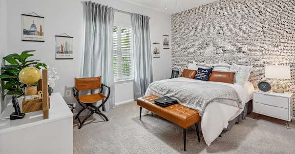 a bedroom with a bed and a ceiling fan