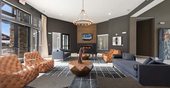 a living room with couches and chairs and a fireplace at Watermark at Harvest Junction, Colorado