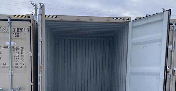 A shipping container is open and empty.