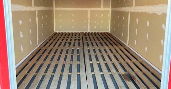 the inside of a storage room with wooden floors and walls