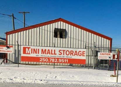 A storage facility called Mini Mall Storage is shown with a red and white sign.