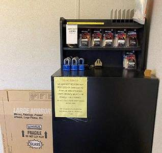 a refrigerator with a box on top of it