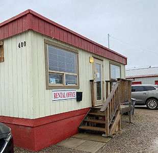 a red and white building with a porch and stairs