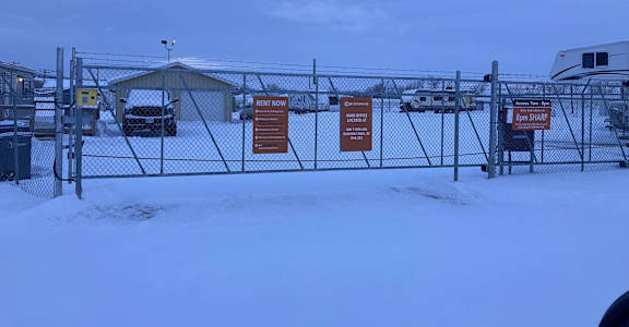 a yard with a chain link fence with signs on it