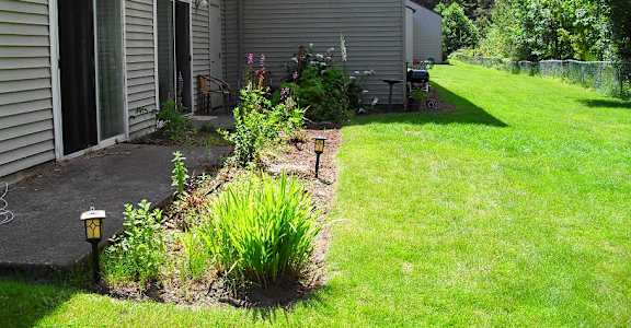 a backyard with a patio and a house