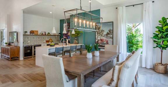 a dining room with a table and chairs and a kitchen at The Villas at Ibis Landing, Florida