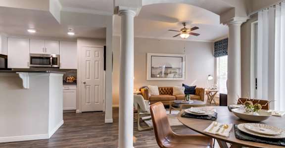 A dining room with a table set for a meal.