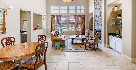 A dining room with a wooden table and chairs.